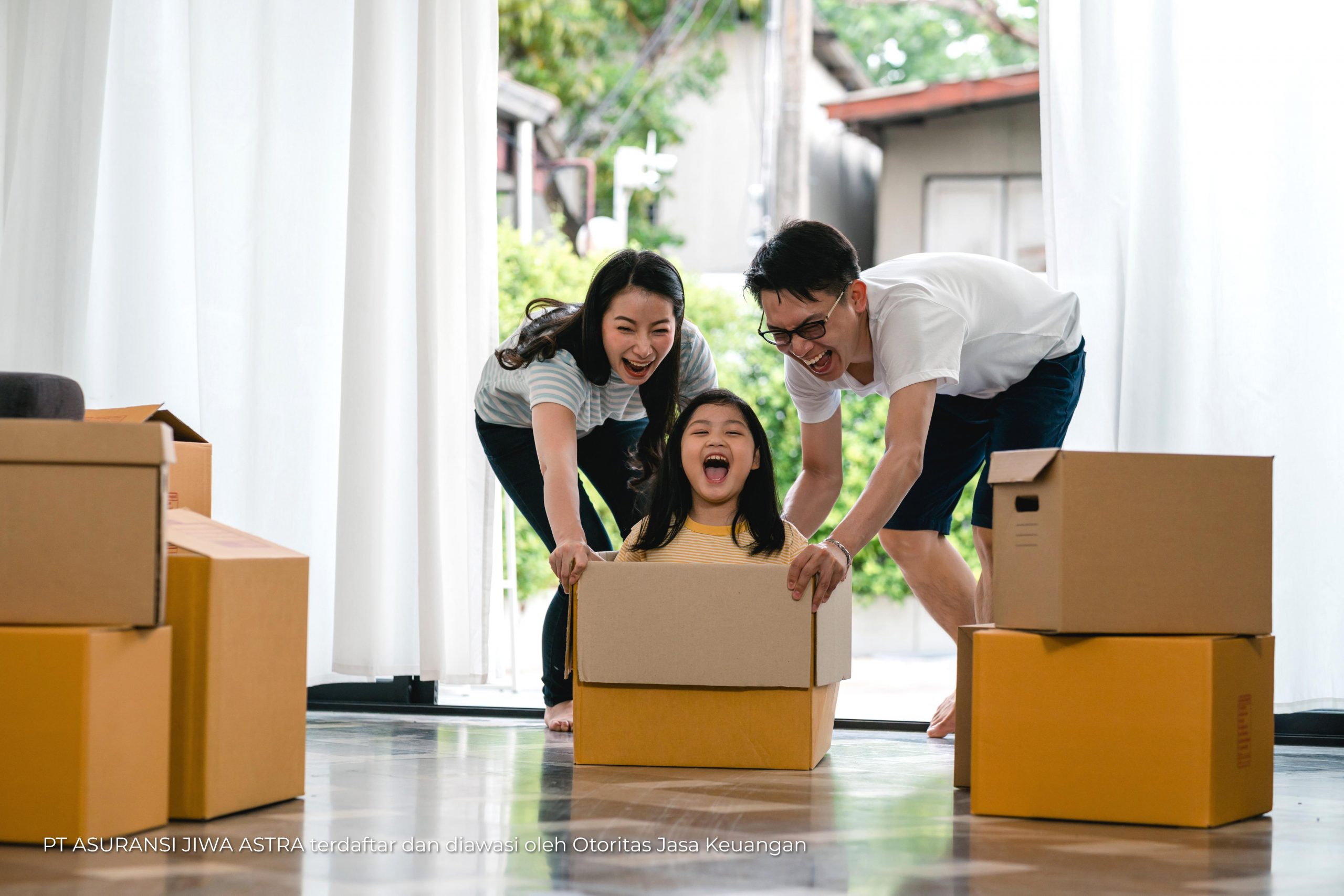 Happy Asian young family having fun laughing moving into new hom